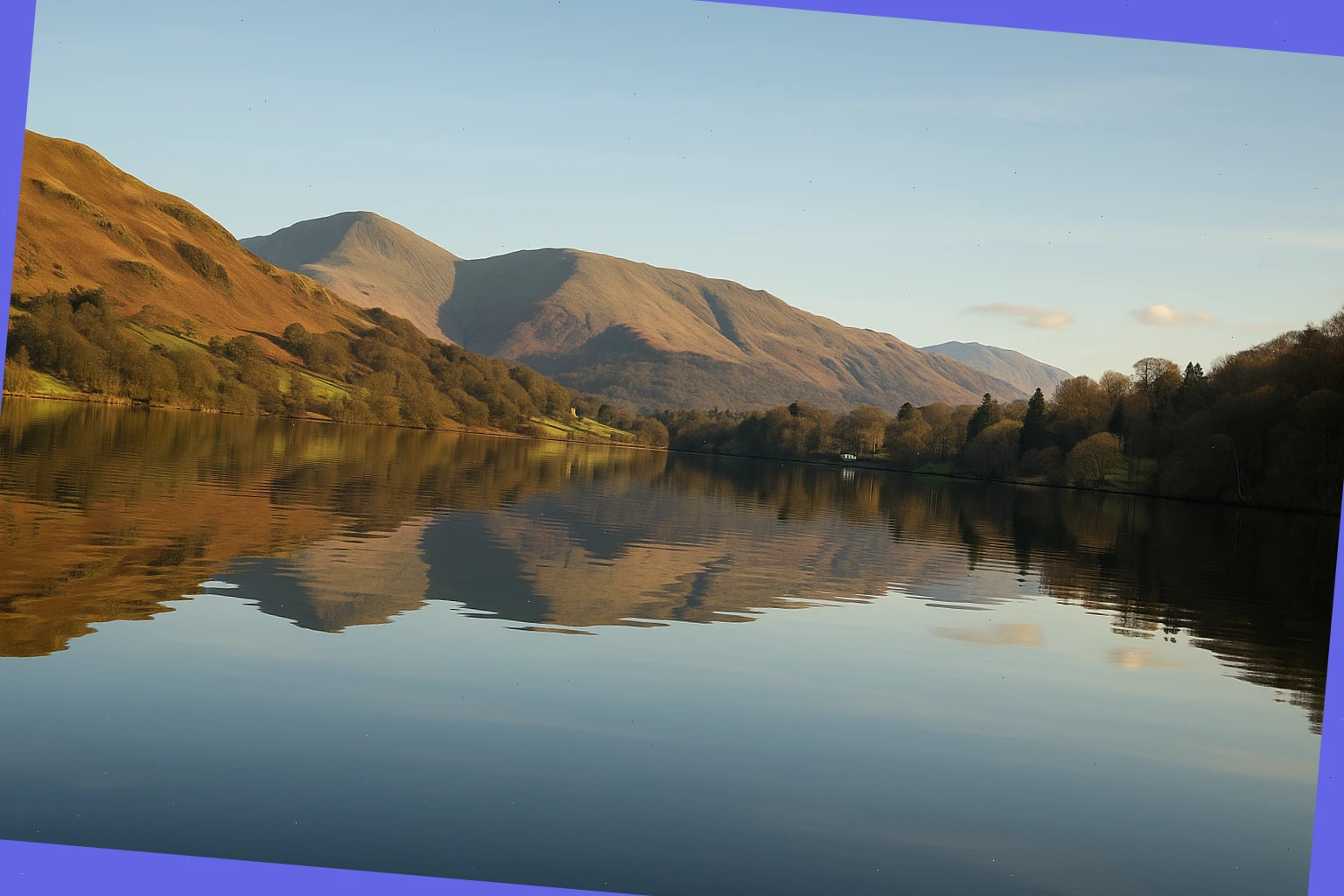 Low fells reflected on still water along a short Windermere route